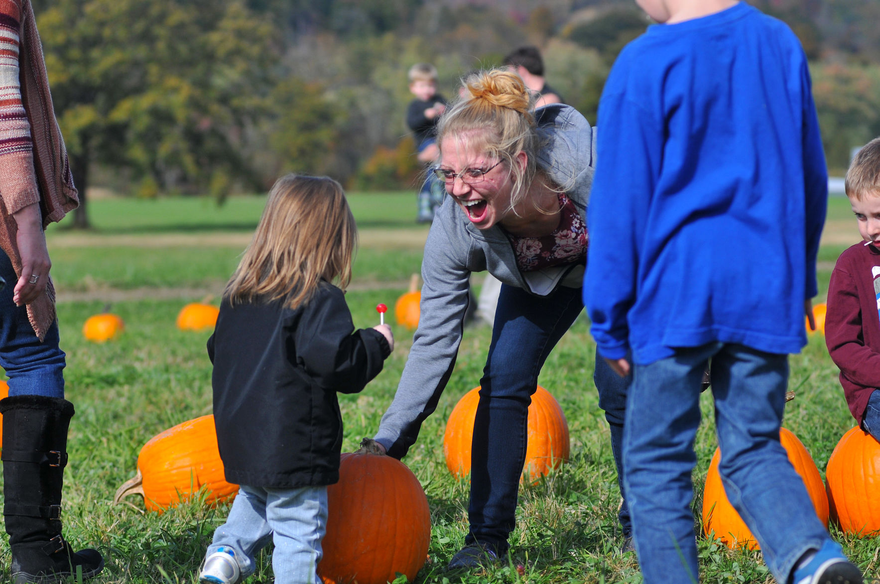 Mckenzie Diltz, 2, picks a pumpkin with her mom Melissa Long